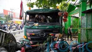 At least 10 die after truck crashes at school bus stop in Indonesia
