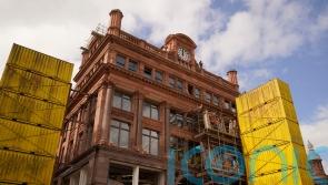Facade of landmark city centre building begins to emerge
