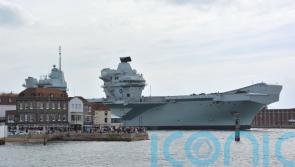 Broken down Royal Navy aircraft carrier returns to home base ahead of repairs