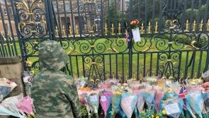 People come to gates of castle to pay respects to the Queen