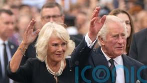 King Charles receives condolences and kisses from crowd at Buckingham Palace