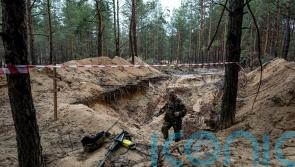Russia leaves death everywhere, says Zelensky, as Ukraine combs mass burial site