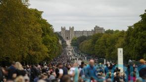 Windsor crowds sing national anthem as they await arrival of Queen’s coffin