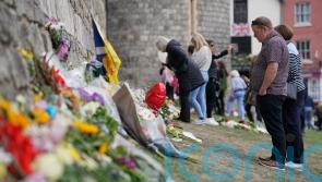 Mourners leave floral tributes to the Queen at Windsor Castle