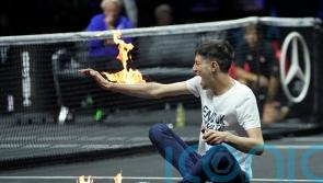 Protester sets his arm on fire during Laver Cup match in London