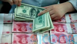 China’s yuan slides to 14-year low against dollar after US rate hikes