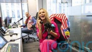Amanda Holden shares centre stage with Pudding the puppy at charity trading day