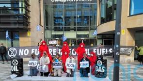 Extinction Rebellion activists dressed in rags and chains protest in Edinburgh