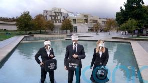 Campaigners protest with dead fish to highlight ‘tragedy’ of salmon industry
