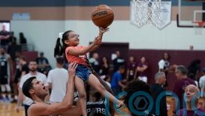 Basketball stars lift children in visit to Texas mass shooting town