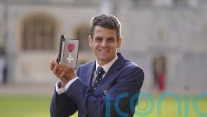 Triathlete Jonny Brownlee targets more Olympic glory as he collects MBE