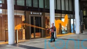 Just Stop Oil activists spray orange paint on Rolex building in central London
