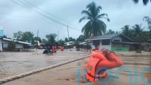 50 dead and dozens feared missing as storm lashes Philippines