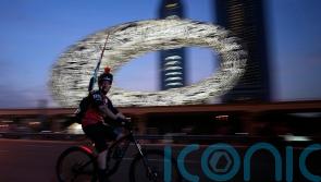 Tens of thousands of cyclists ride on skyscraper-lined superhighway in Dubai