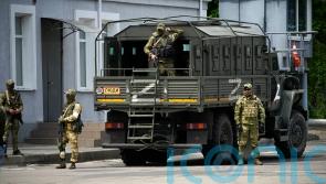 Russia says retreat from key city has begun, but Ukraine remains cautious