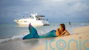 A mermaid who could not swim when she took on the role has saved a scuba diver&rsquo;s life after finding him unconscious