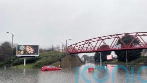 Search resumes for woman swept into river amid heavy rain