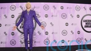 Machine Gun Kelly dons extravagant spiked suit at the AMAs