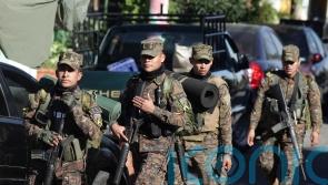 El Salvador seals off town as 10,000 police officers and soldiers hunt for gang