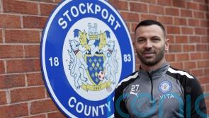 Phil Bardsley signs for Stockport and donates his wages to charity