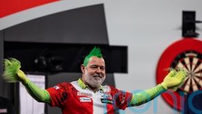 Peter Wright launches World Championship defence in style with comfortable win