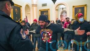 Capitol rioter who led mob chasing police officer is jailed for five years