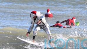 Frigid weather fails to stop Florida’s surfing Santas