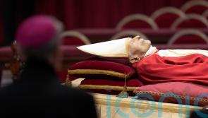 Tens of thousands view Pope Benedict lying in state at Vatican