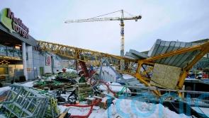 One person dead as crane falls on to shopping centre in Norway during high winds