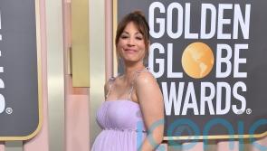 Kaley Cuoco debuts growing baby bump on Golden Globes red carpet