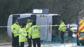 Double-decker bus overturns in crash with motorcycle
