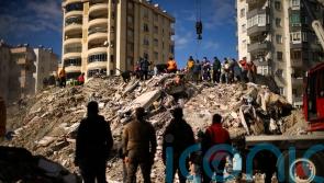 Search teams and emergency aid arrive as earthquake death toll passes 7,700
