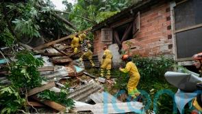 Search for survivors after landslides and flooding kill 36 in Brazil