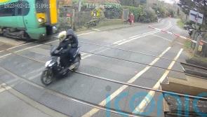 Footage shows moped narrowly avoiding 70mph train at level crossing