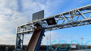 Motorway closed after truck hits overhead gantry