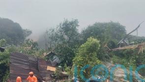Rescuers search for dozens buried in Indonesian landslides