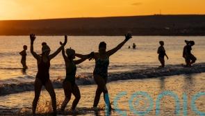 Sub-zero temperatures fail to deter swimmers from sunrise dip