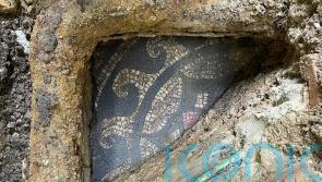Work starts to unearth mosaic under pavement outside vape shop