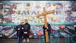 Communities unite to form human chain at peace wall to mark accord’s anniversary