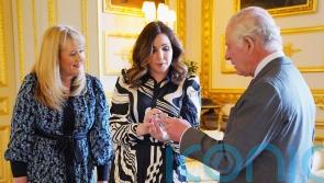 King is presented with £5 coin featuring his crowned portrait for first time