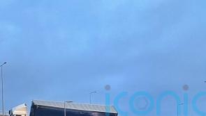 Lorry left hanging above A road after crashing into bridge barrier