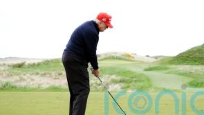 Donald Trump jokes with crowd as he plays golf at his Turnberry course