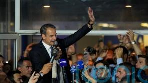 Greek prime minister to seek outright majority after huge election lead