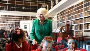 Queen Camilla meets children and volunteers at historic library
