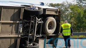 Driver charged after bus carrying wedding guests rolls over, killing 10