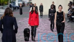 Chanel model walks a dog on the catwalk at haute couture show