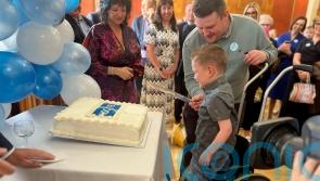 Daithi Mac Gabhann cuts cake on 75th anniversary of health service