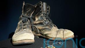 Alan Alda selling boots and dog tags from M*A*S*H