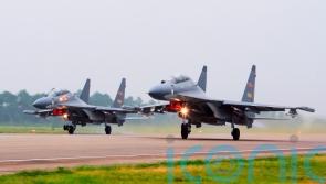 China sends warplanes and navy ships towards Taiwan in show of force