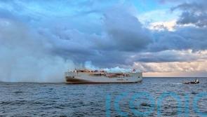 Crew member dies as fire on ship carrying 3,000 cars burns out of control